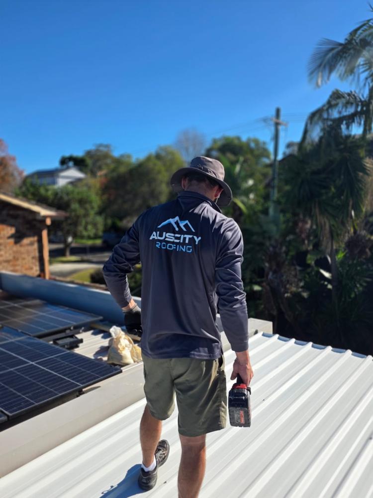 Auscity roofer on a completed metal roof