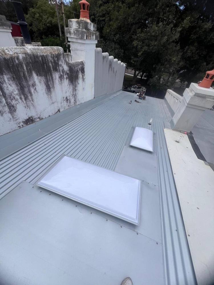 Metal roof with new skylights on a heritage home