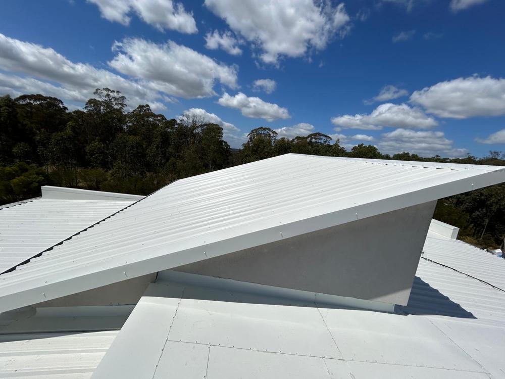 Finished skillion metal roof against a blue sky